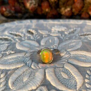 Opal unusual iridescent hue gold silver ring